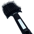 A close-up of a black hair extension brush with boar bristles and a flexible handle.